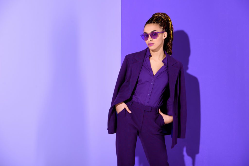 Woman Wearing Purple Suit & Sunglasses